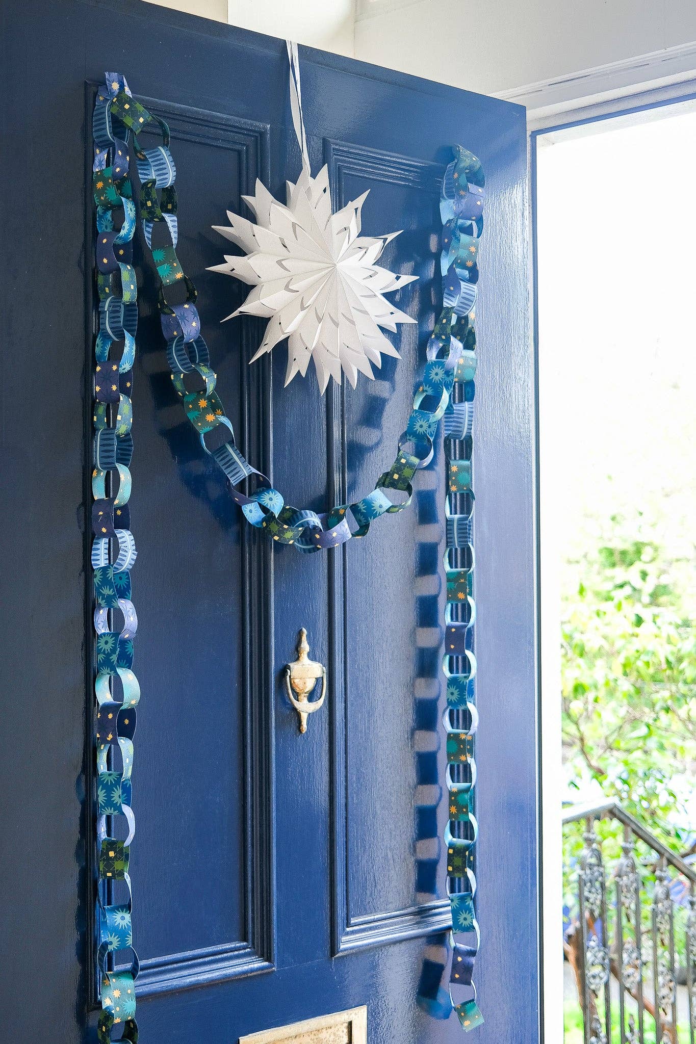 Long length of blue and yellow recycled paper chain hanging as decor