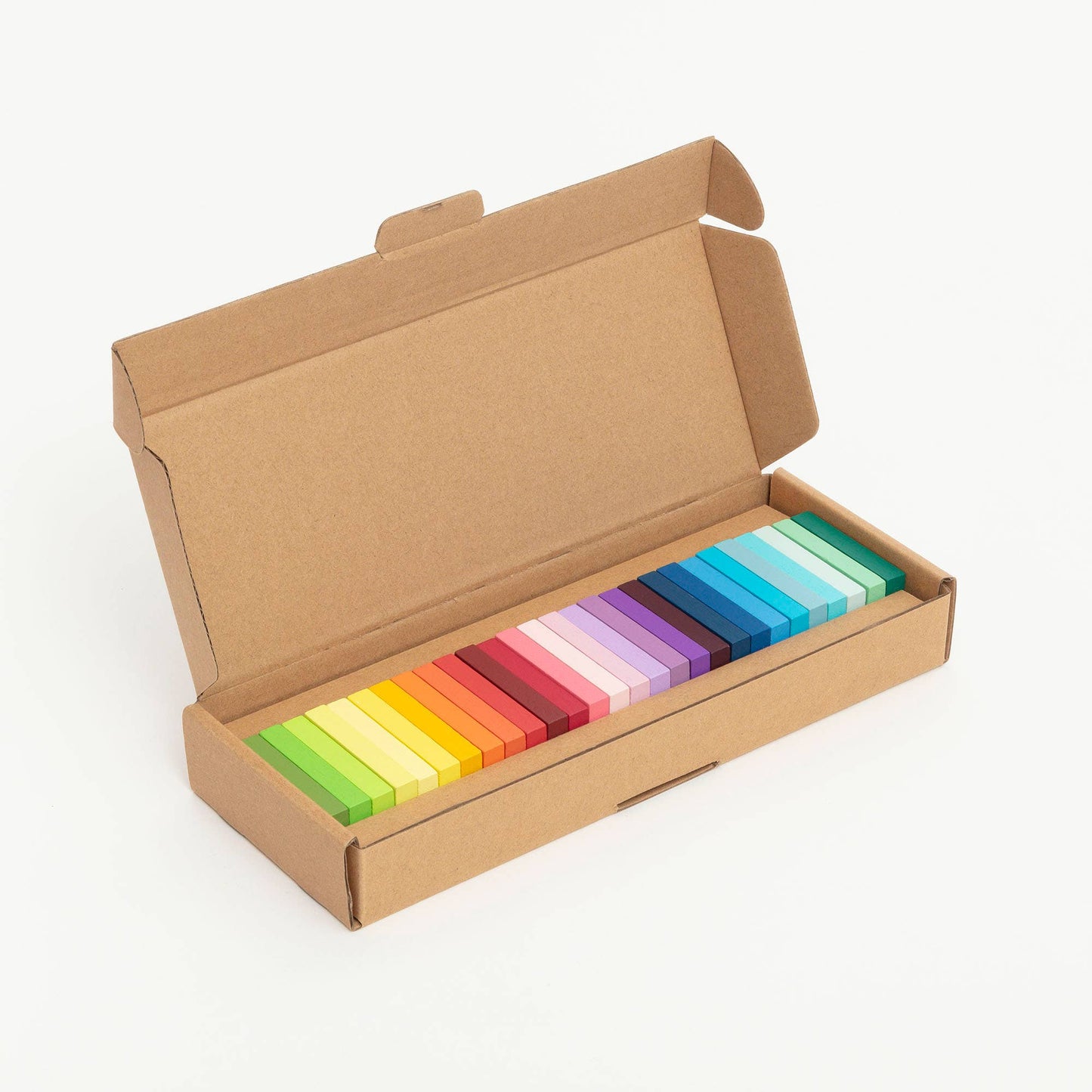 Set of colourful dominos  in a cardboard box on a white background