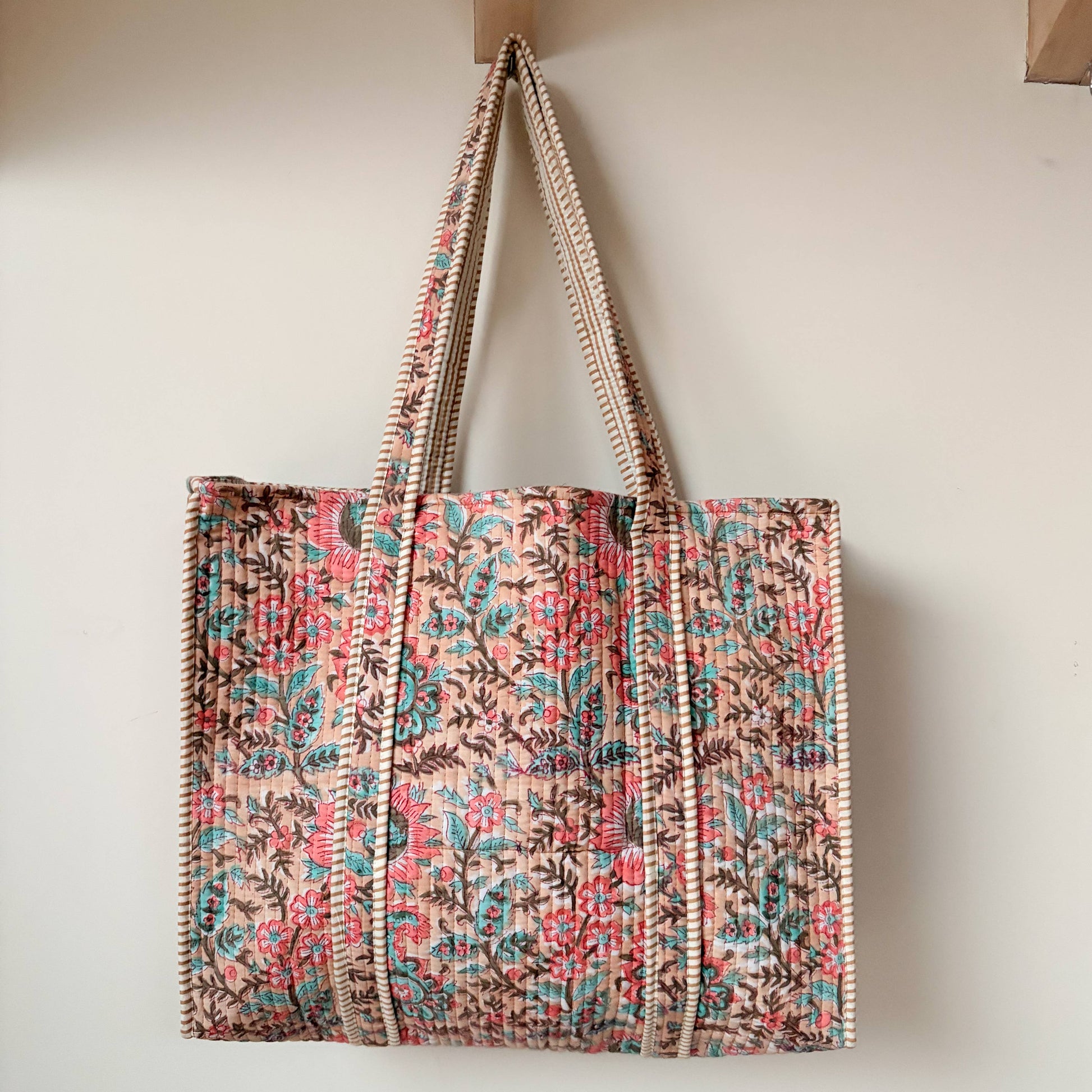 Block printed cotton quilted tote bag with intricate floral design