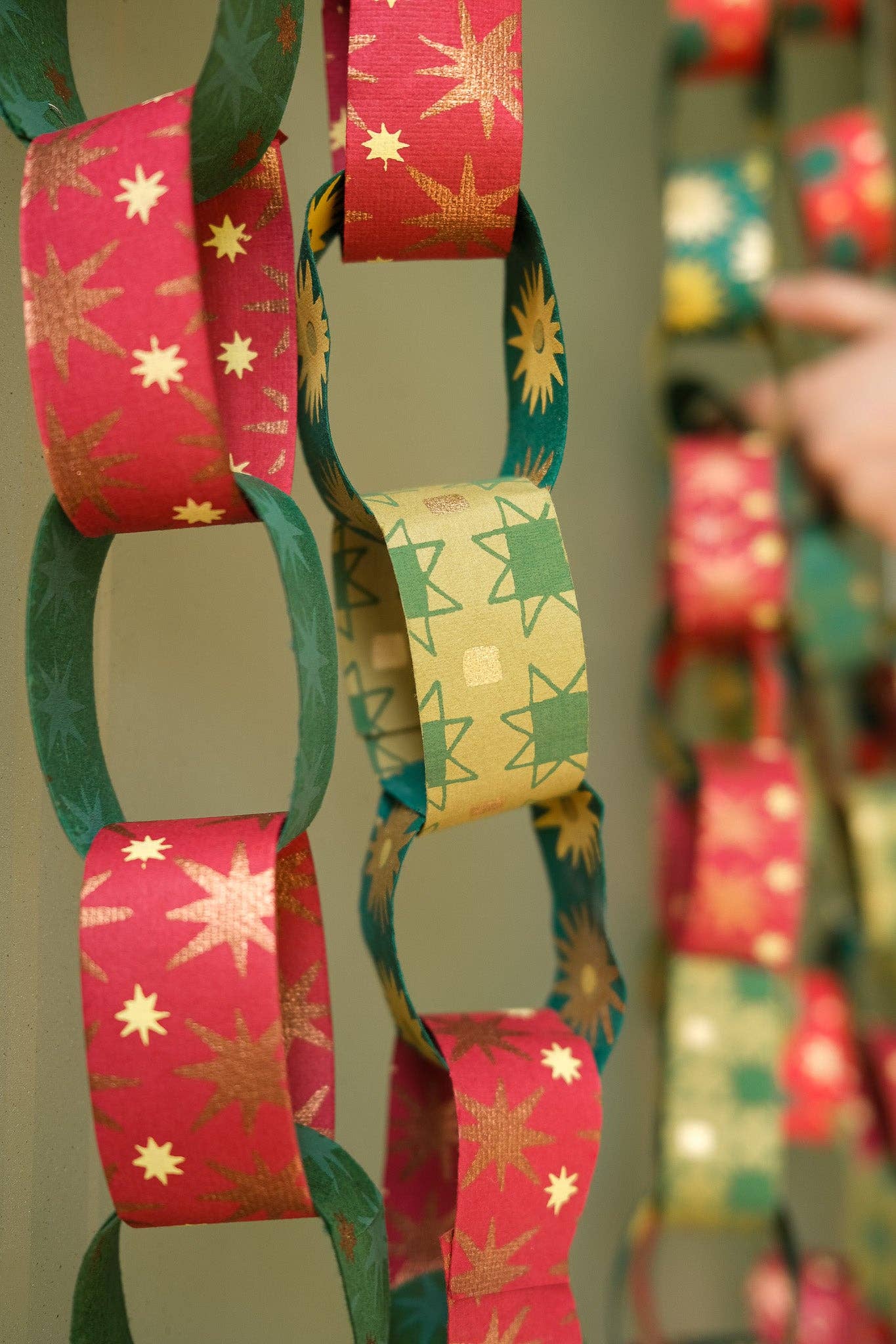 Recycled festive paper chain strips, hand-printed double-sided, eco-friendly decoration kit.