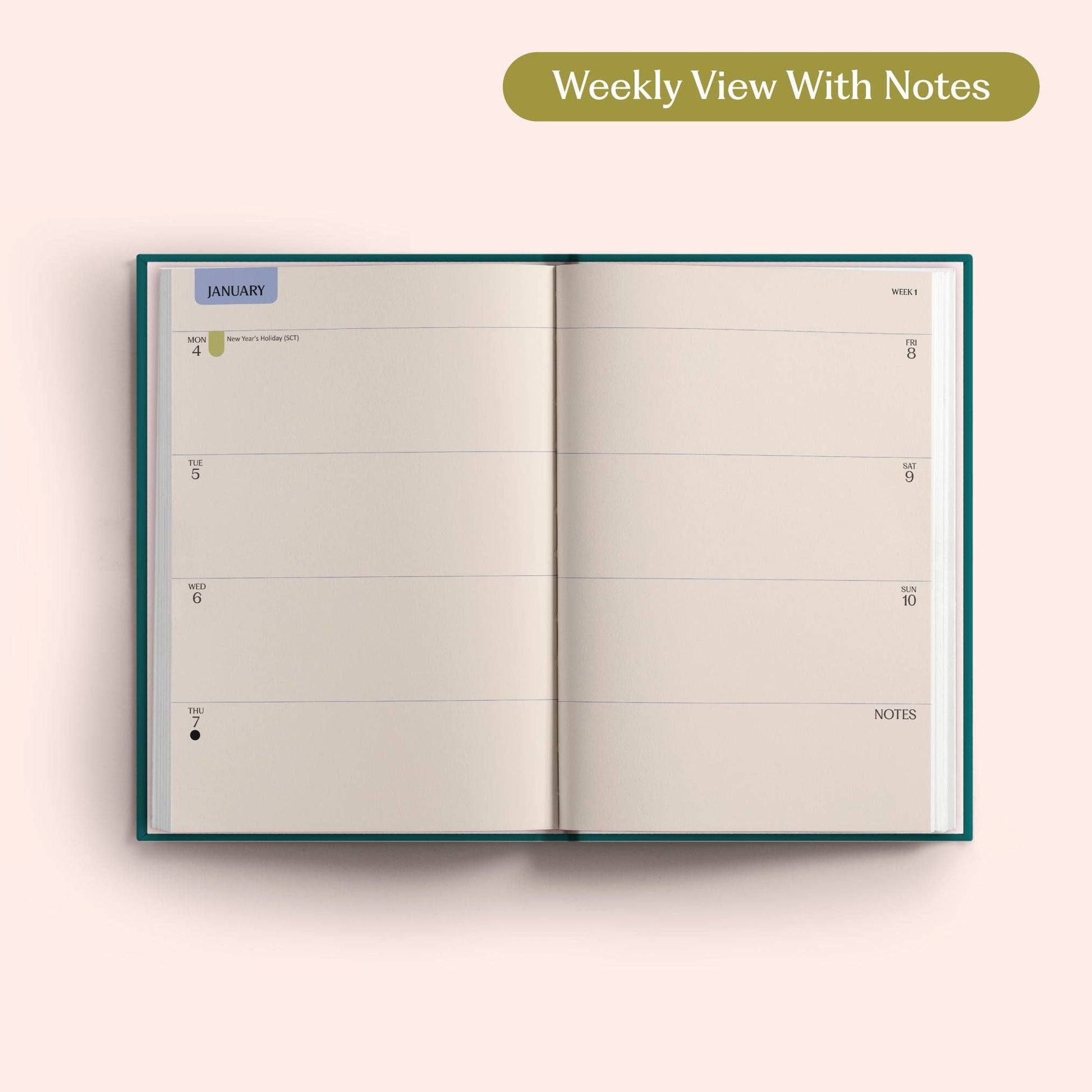 Teal diary styled on a desk with stationery