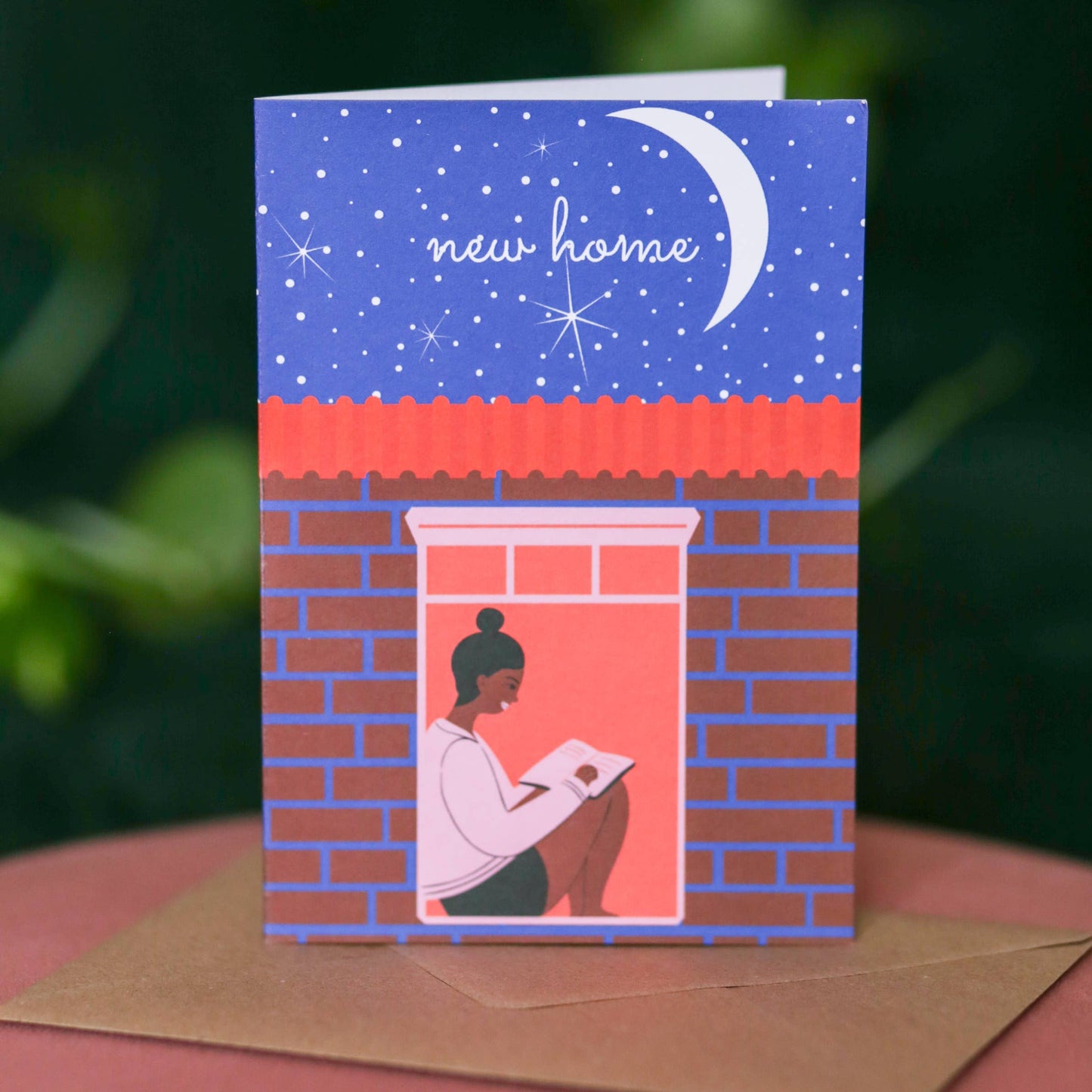 Colourful A6 housewarming card featuring a Black character reading