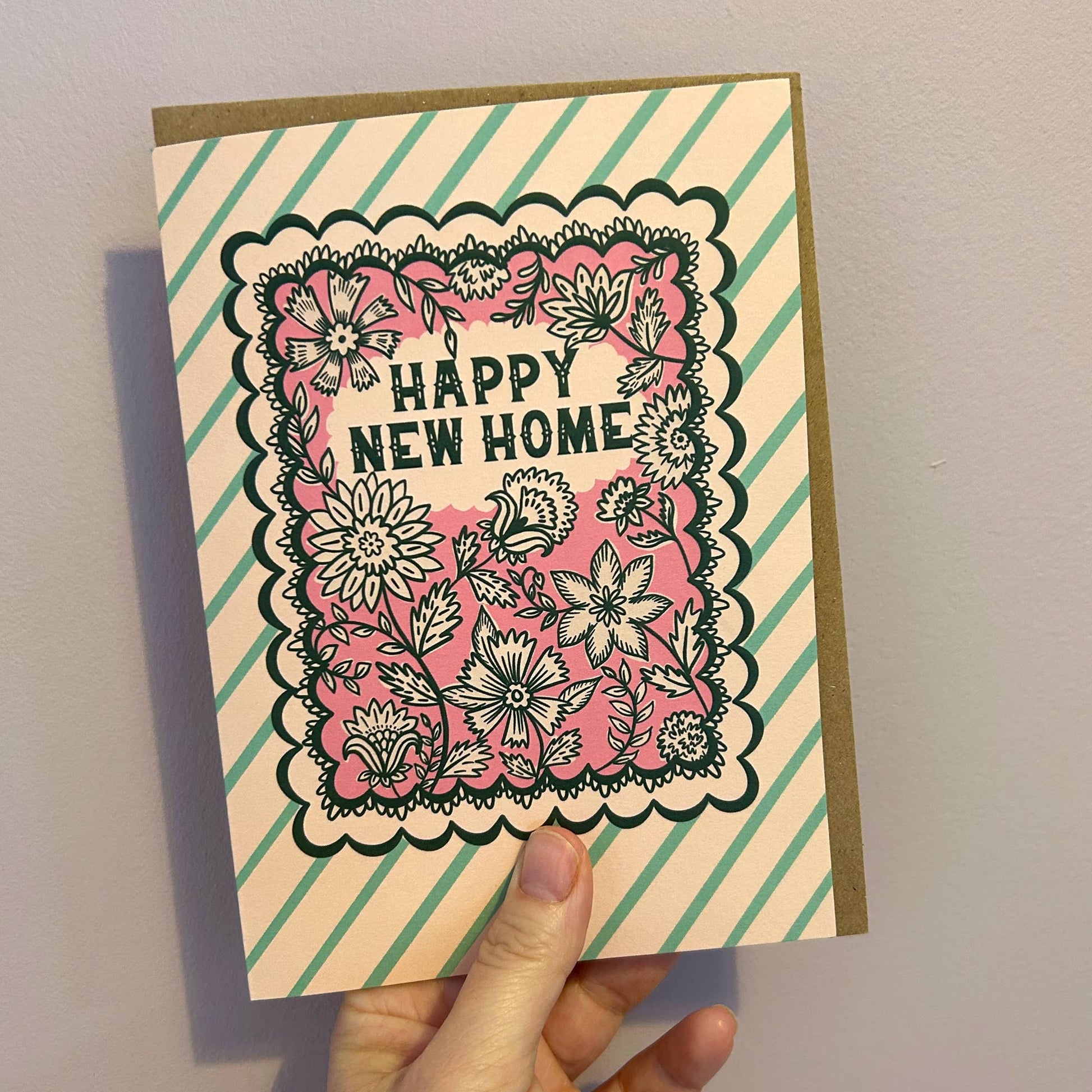 Close-up of intricate Indian floral print on new home card