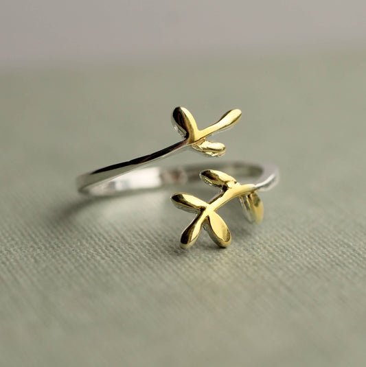 This sweet and delicate botanical inspired ring is made from Sterling silver, with touches of gold plating on the tips. The ring has an open, or adjustable form which can fit most fingers.