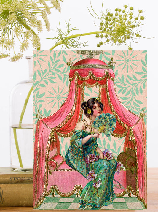 Beautiful vintage card of a lady in a stunning oriental dress under a canopy fanning herself.