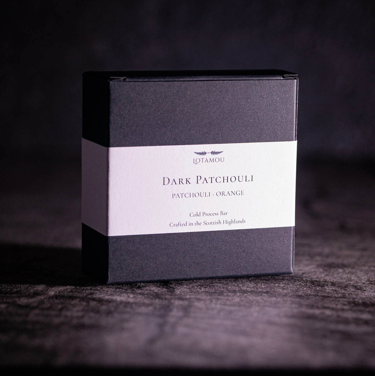 Cold-process organic soap bar showing a rich grey texture