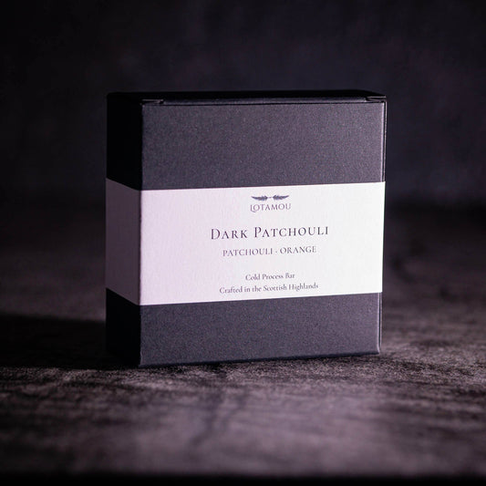 Cold-process organic soap bar showing a rich grey texture