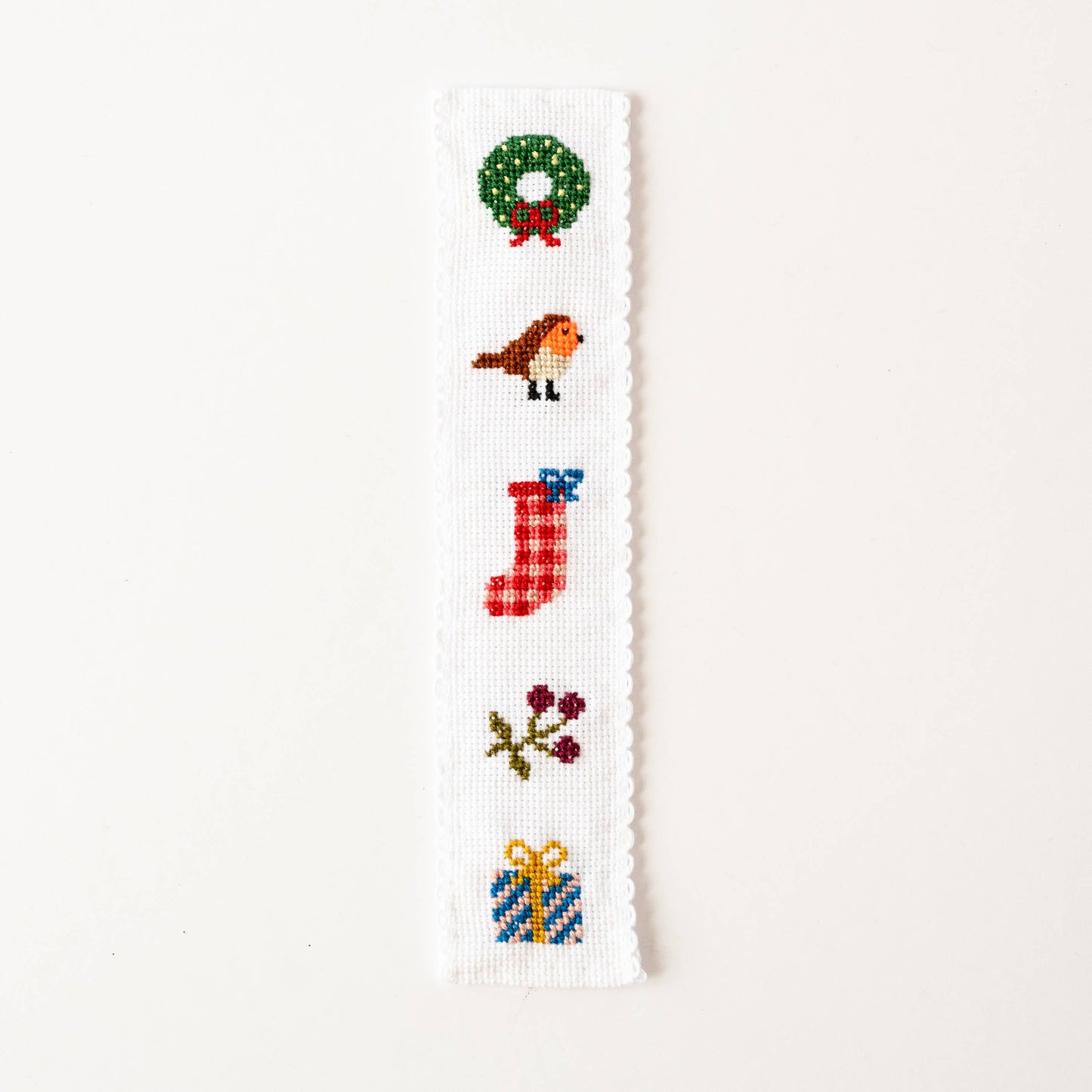 Completed festive cross stitch bookmark featuring stocking and robin