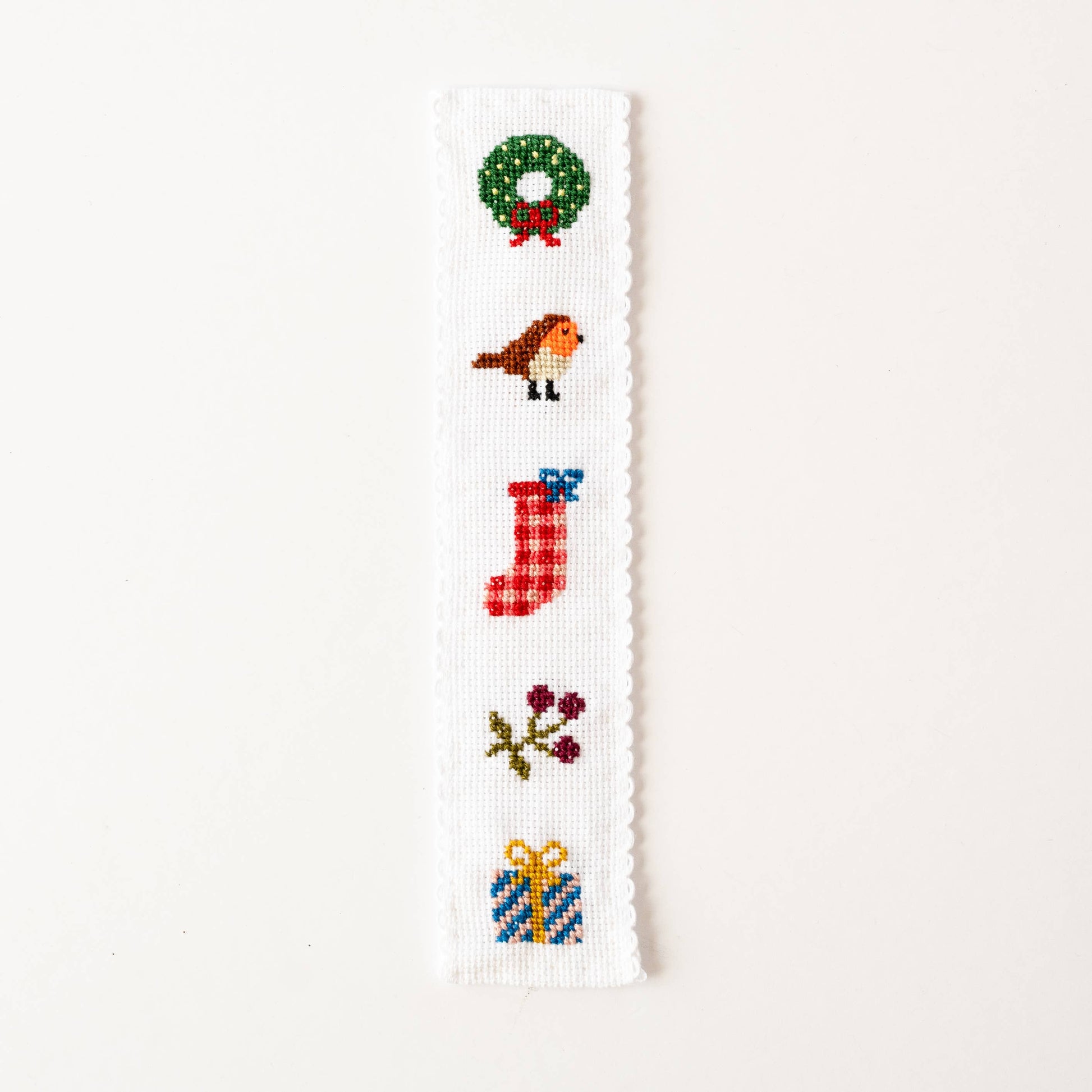 Completed festive cross stitch bookmark featuring stocking and robin