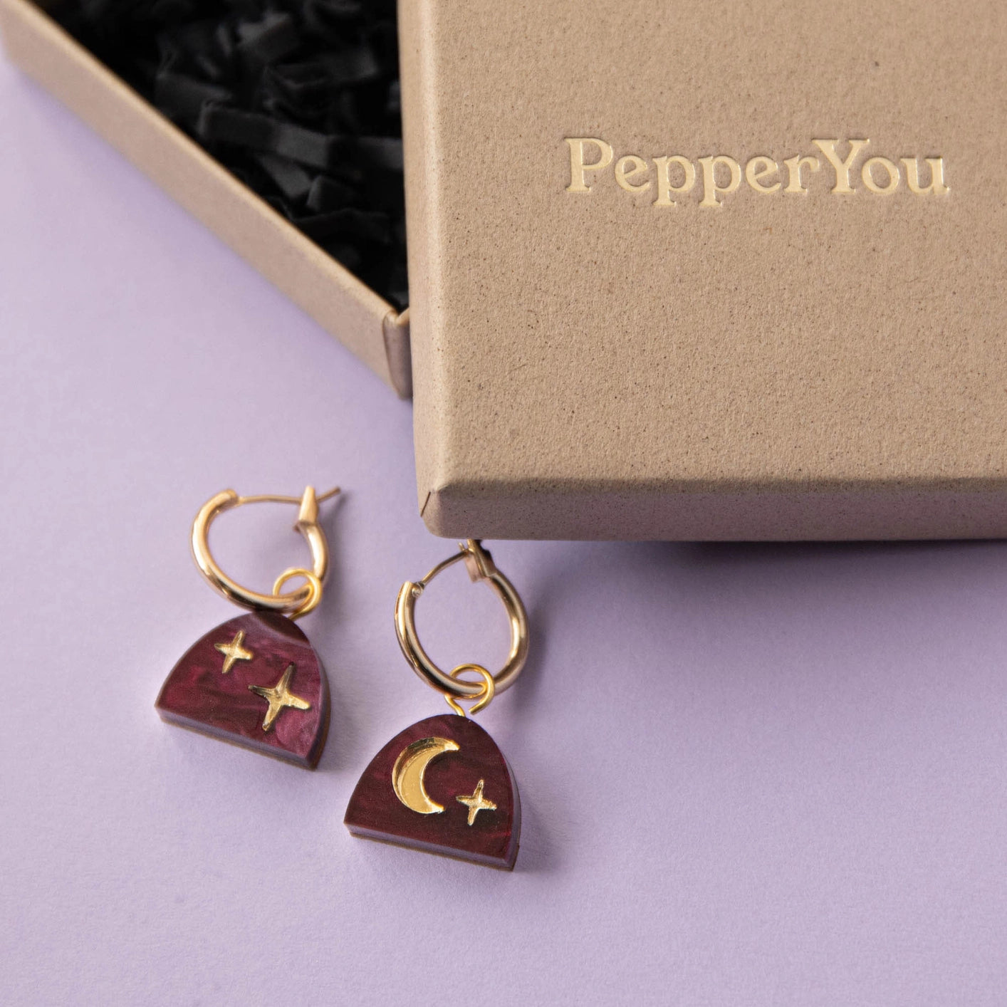 Model wearing Mini Moon Rising Arc Hoop Earrings, displaying the elegant merlot red marble and sustainably sourced wood design.