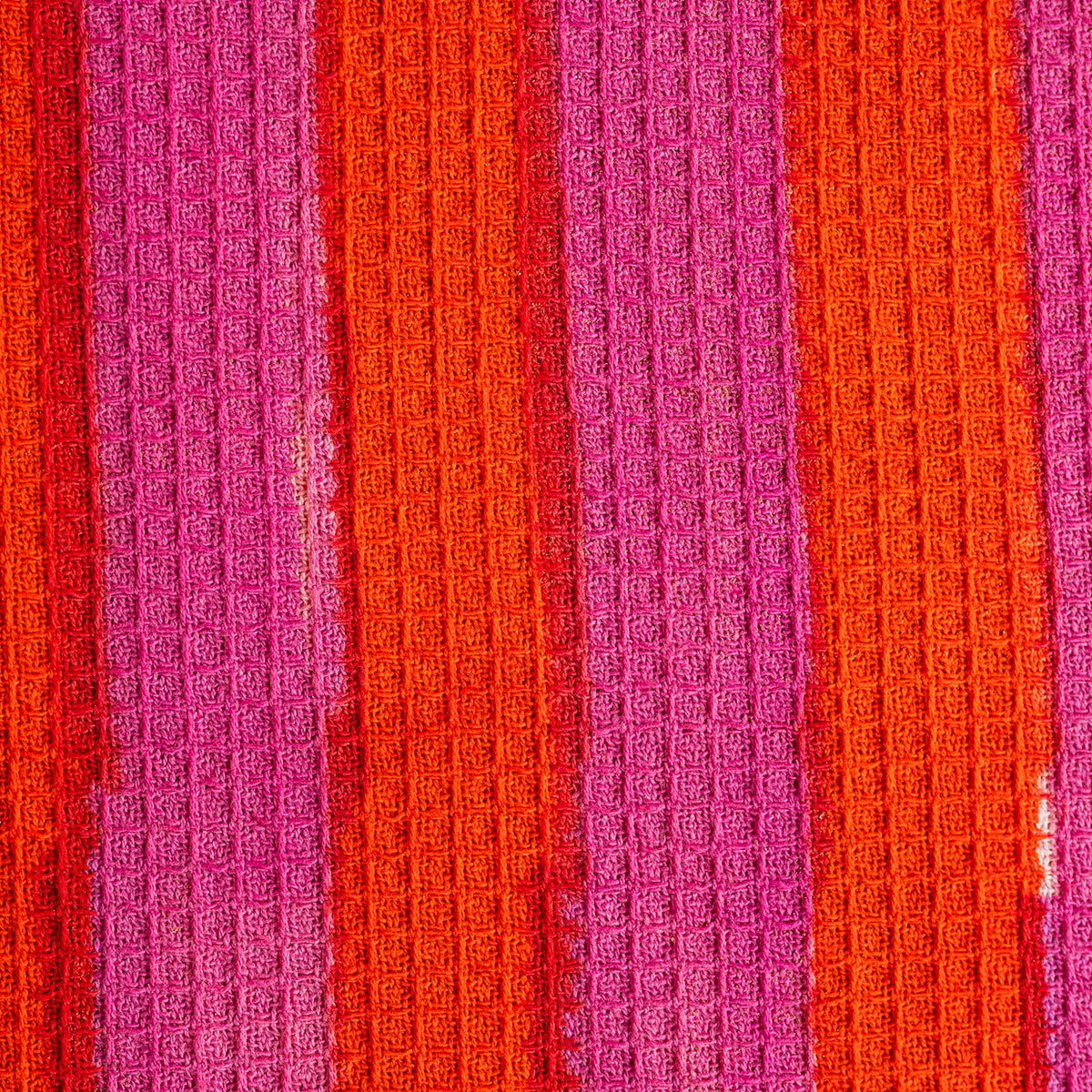 Detail of hand block printed terracotta stripe tea towel with hanging loop