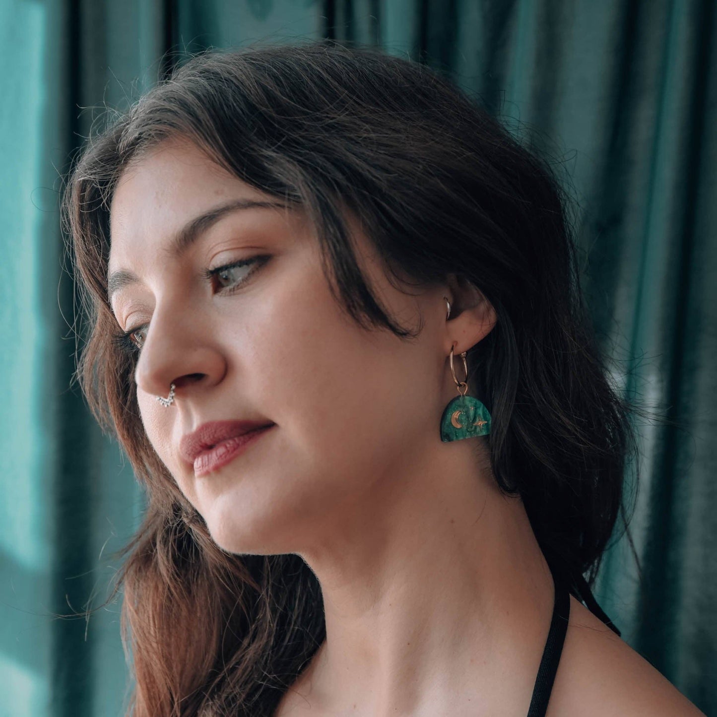 Model wearing Teal Marble & Gold Moon Rising Arc Hoop Earrings, showcasing their elegant design and 20mm diameter.