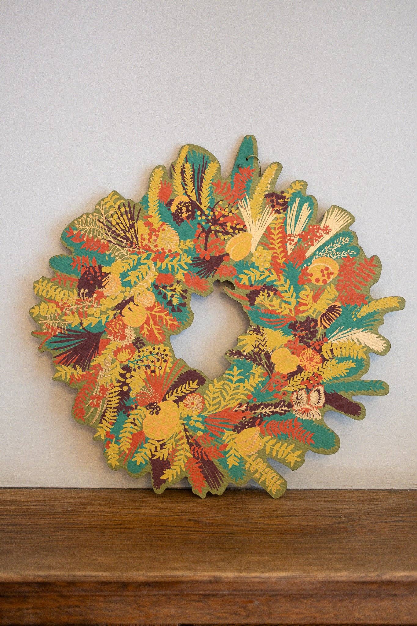 Hand-printed cotton board wreath with winter blooms, sustainable Christmas ornament