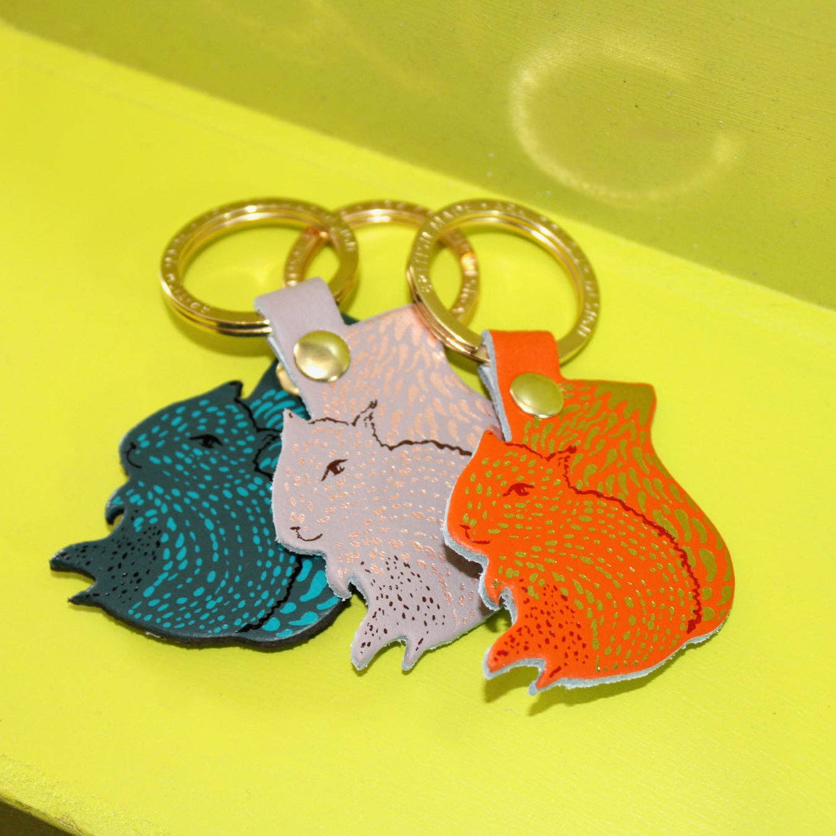 Squirrel leather keyring alongside sustainable recycled packaging