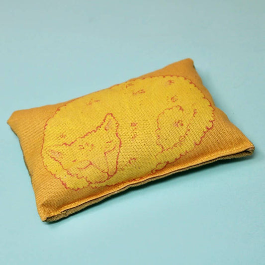 Yellow sleeping cat lavender bag made with organic cotton, illustrated and filled with calming lavender.
