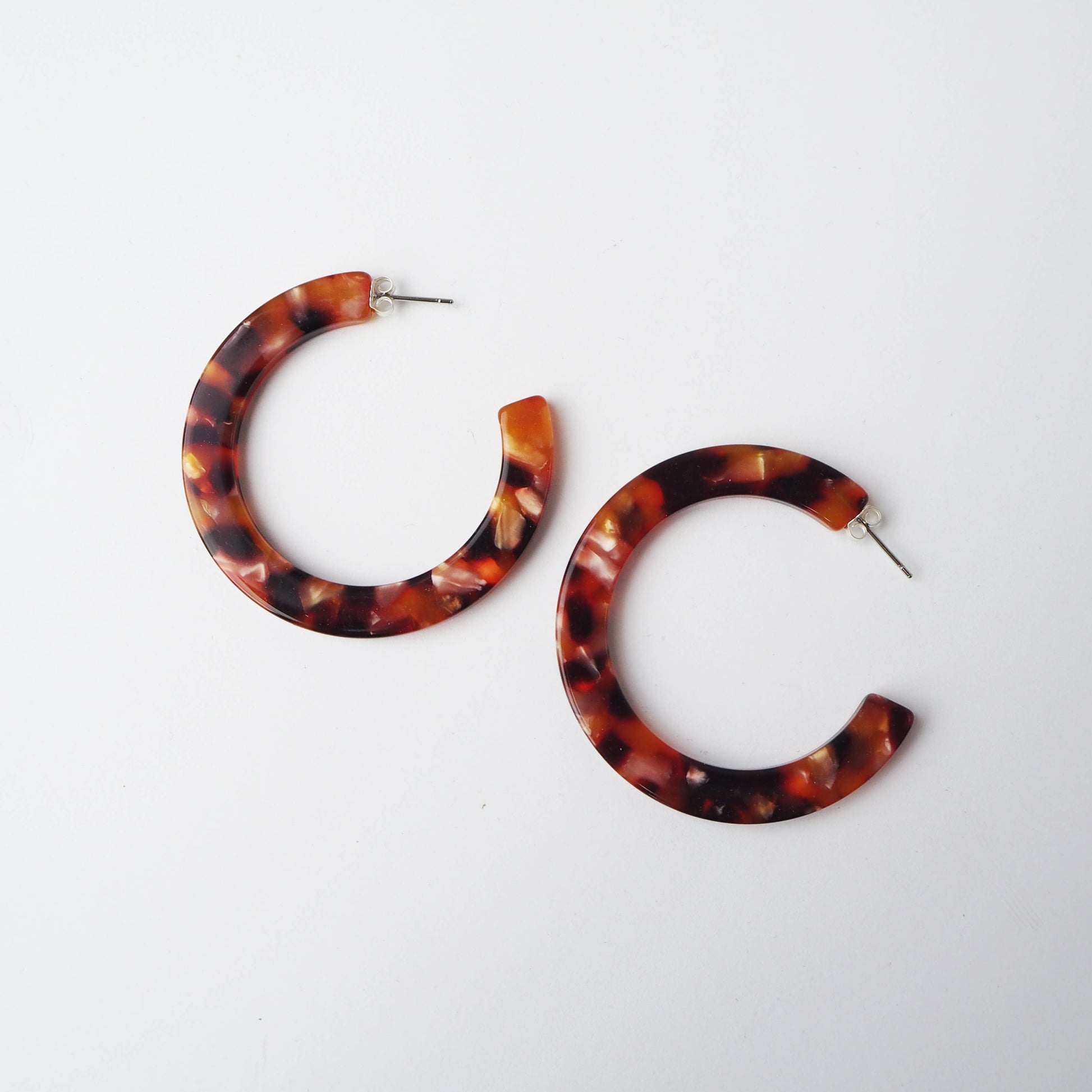 Close up of pink and brown acetate texture on statement hoop earrings