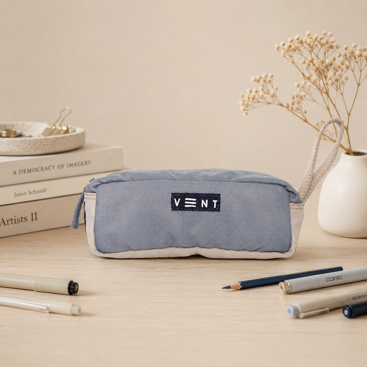 Top zip closure detail of dusty blue recycled pencil pouch