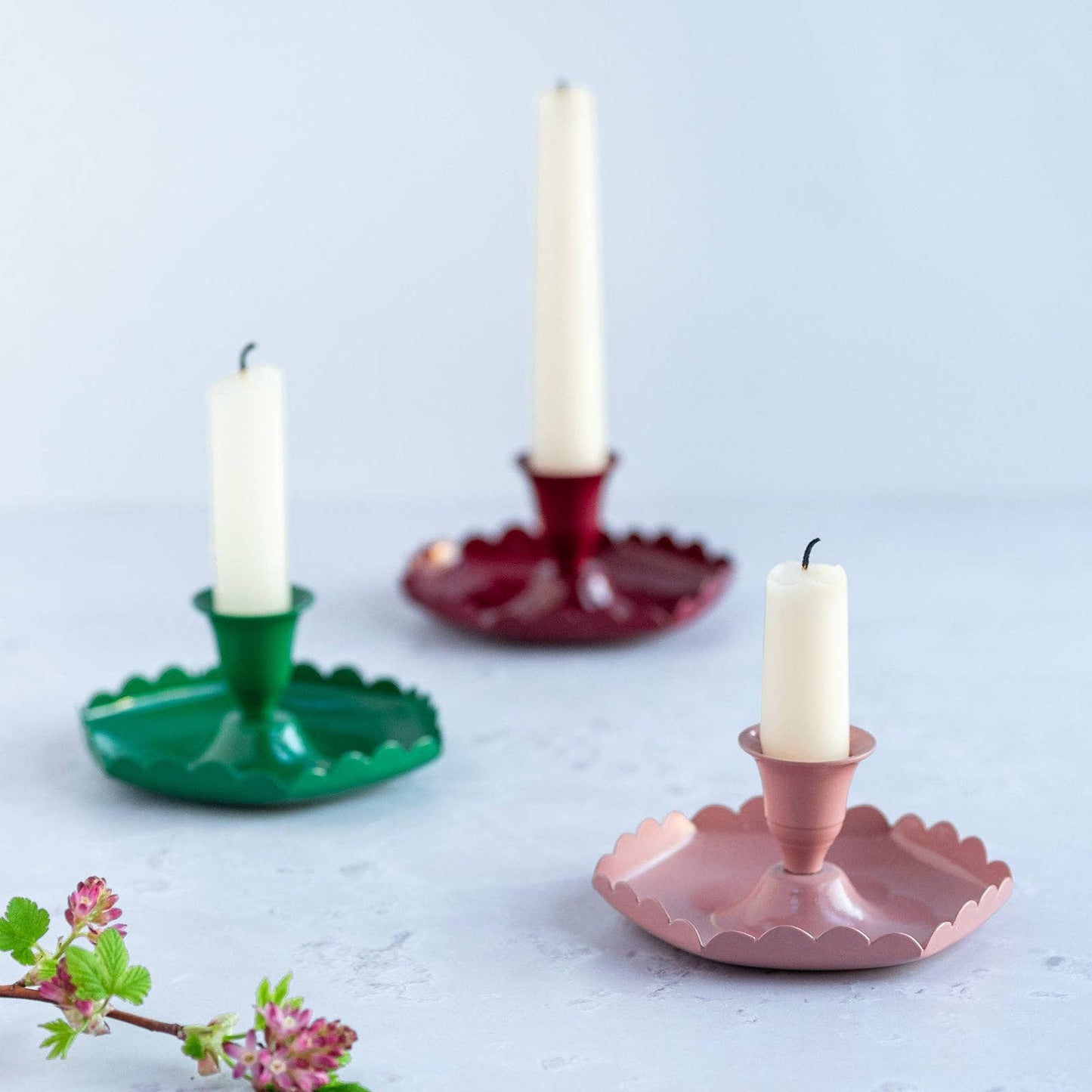 Hand-painted emerald green candle holder on a dining table