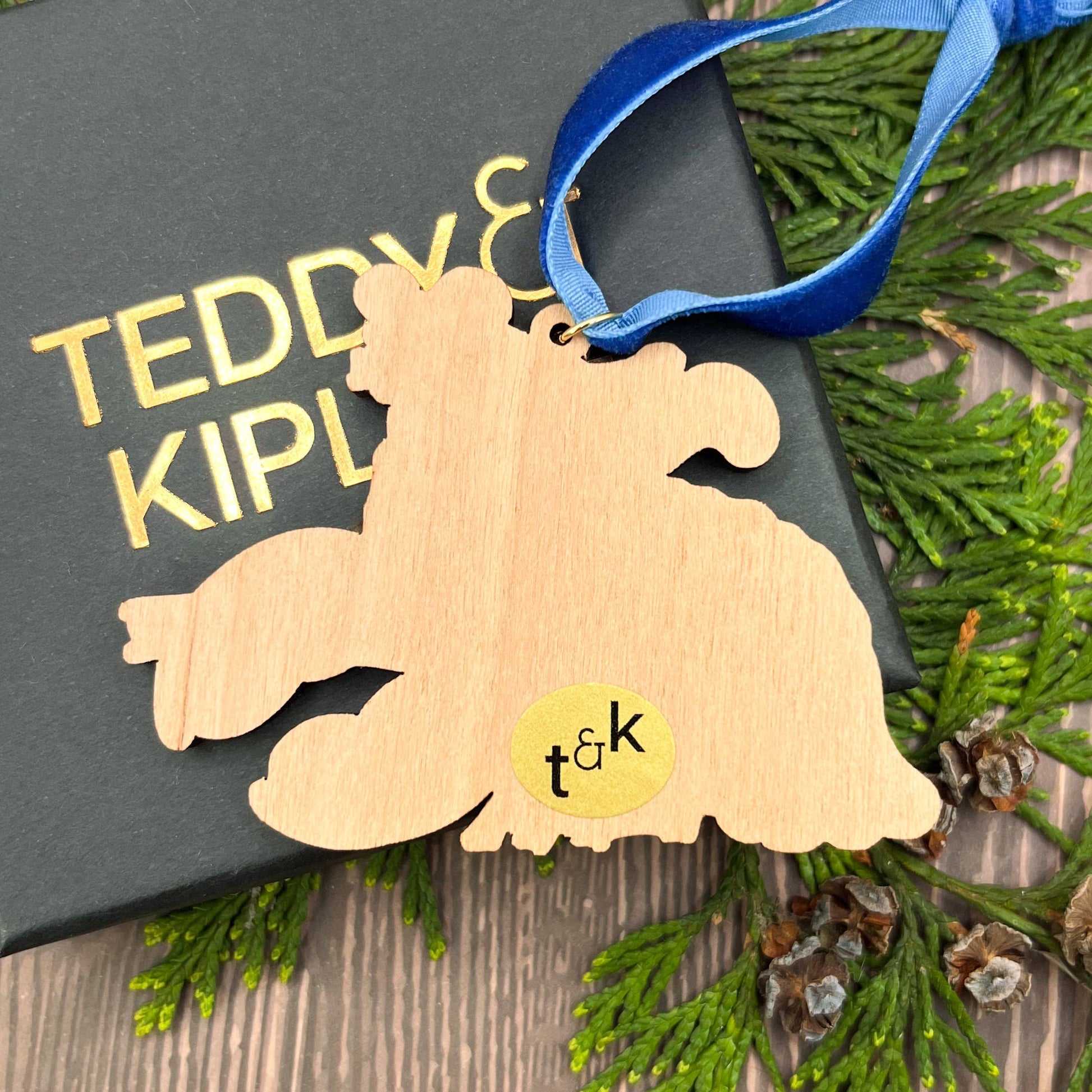 Mouse On A Lobster wooden Christmas tree decoration with Teddy & Kipling illustration, sustainably certified cherry wood, gold-plated ring, and royal blue velvet ribbon.