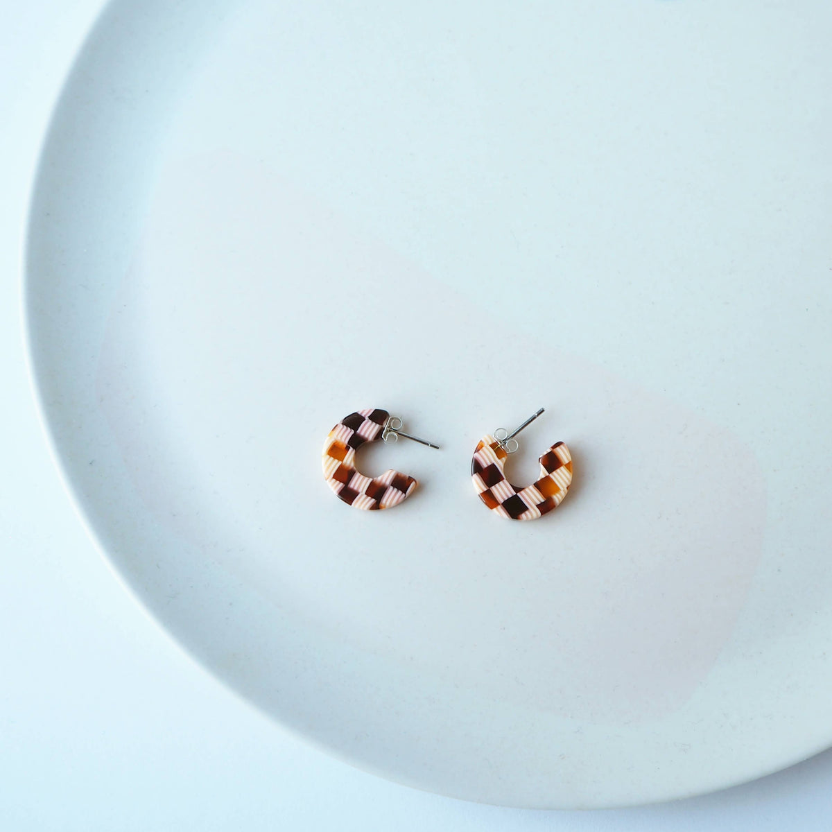Side view of chunky honey checkerboard hoop earrings