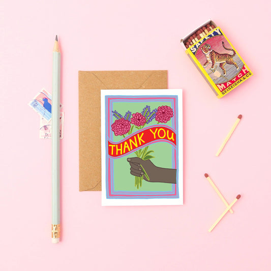 Mini Thank you Card. Thank You! Featuring a black hand and a colourful bunch of flowers. With the words THANK YOU across the middle of the card in bold yellow writing.