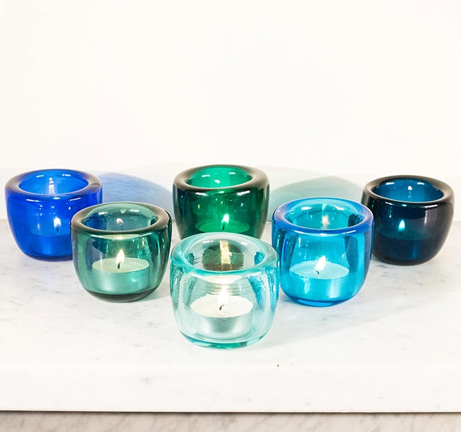 Made from hand-blown glass, these tealight holders are rich with colour and twinkle beautifully when lit, in a jewel-like way.