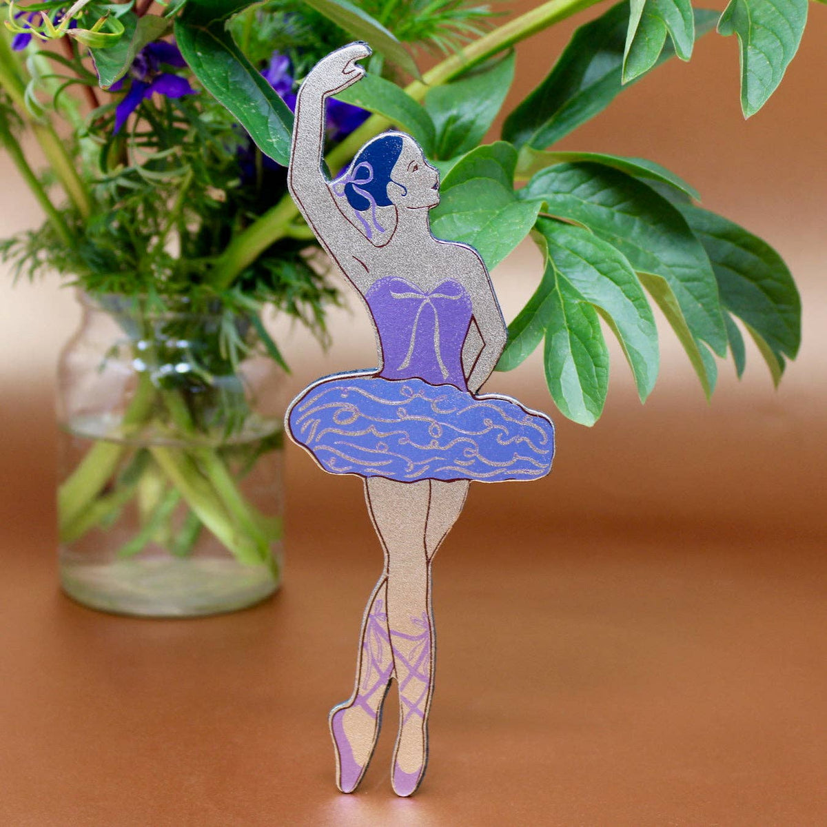 Close up of shiny and matte foil detailing on ballerina leather bookmark
