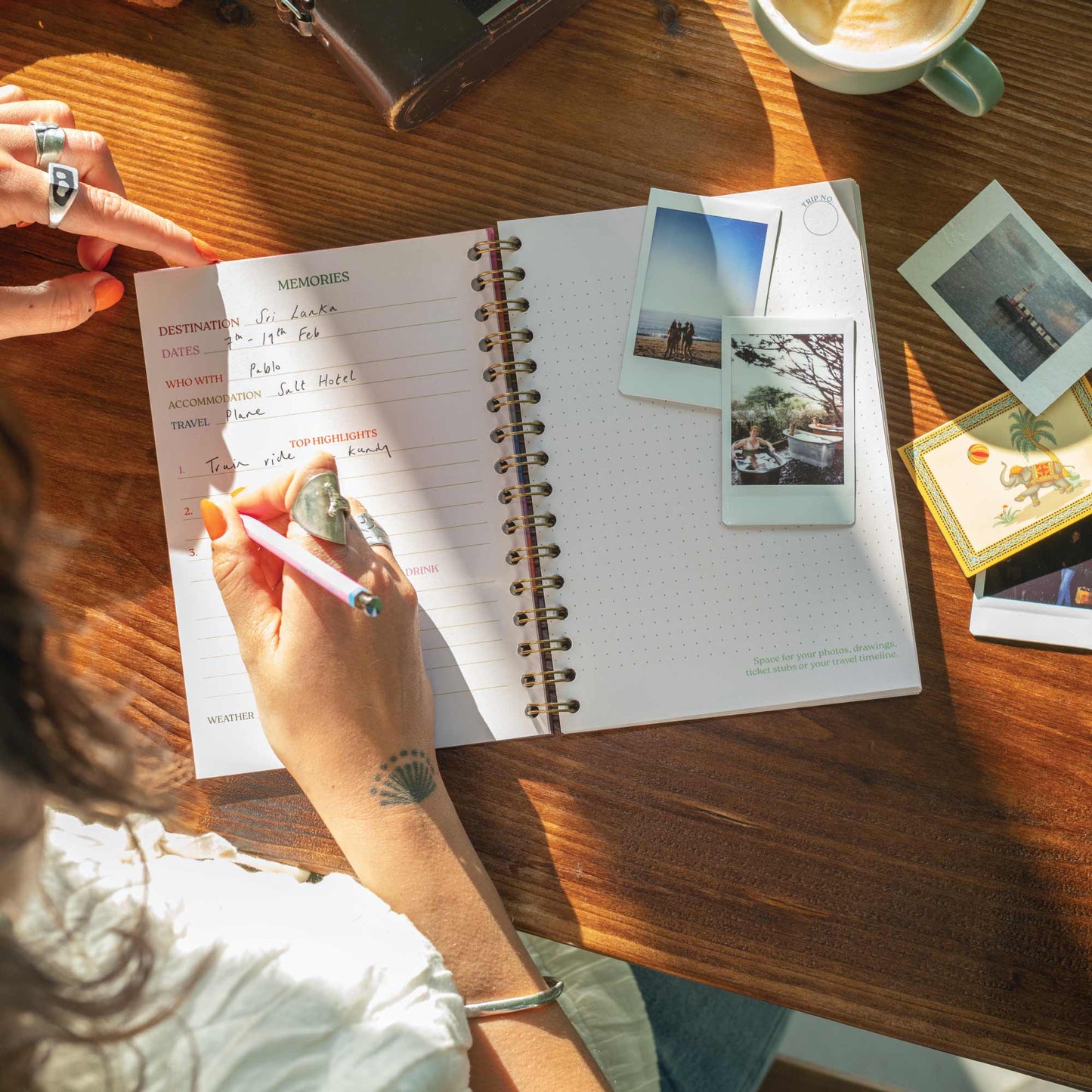 Open A5 Wanderlust Travel Journal displaying colourful internal pages