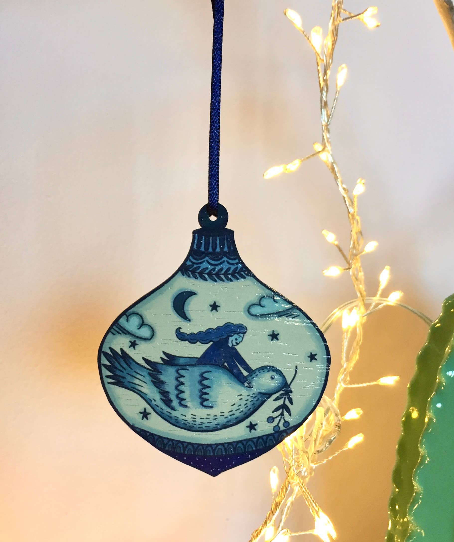 Close-up of Su Owen Sustainable Walnut Wood Bird Decoration with Satin Ribbon