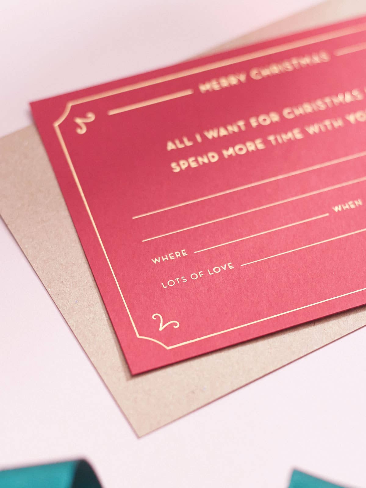 Red Christmas Gift Voucher by Another Loop, gold foil experience token on rich red sustainable card, A6 blank ticket, 100% recycled Kraft envelope.