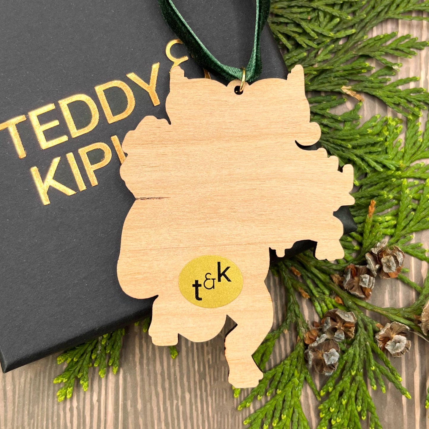 Krampus wooden Christmas tree decoration featuring Teddy & Kipling illustration, sustainably certified cherry wood, gold-plated ring, and dark green velvet ribbon