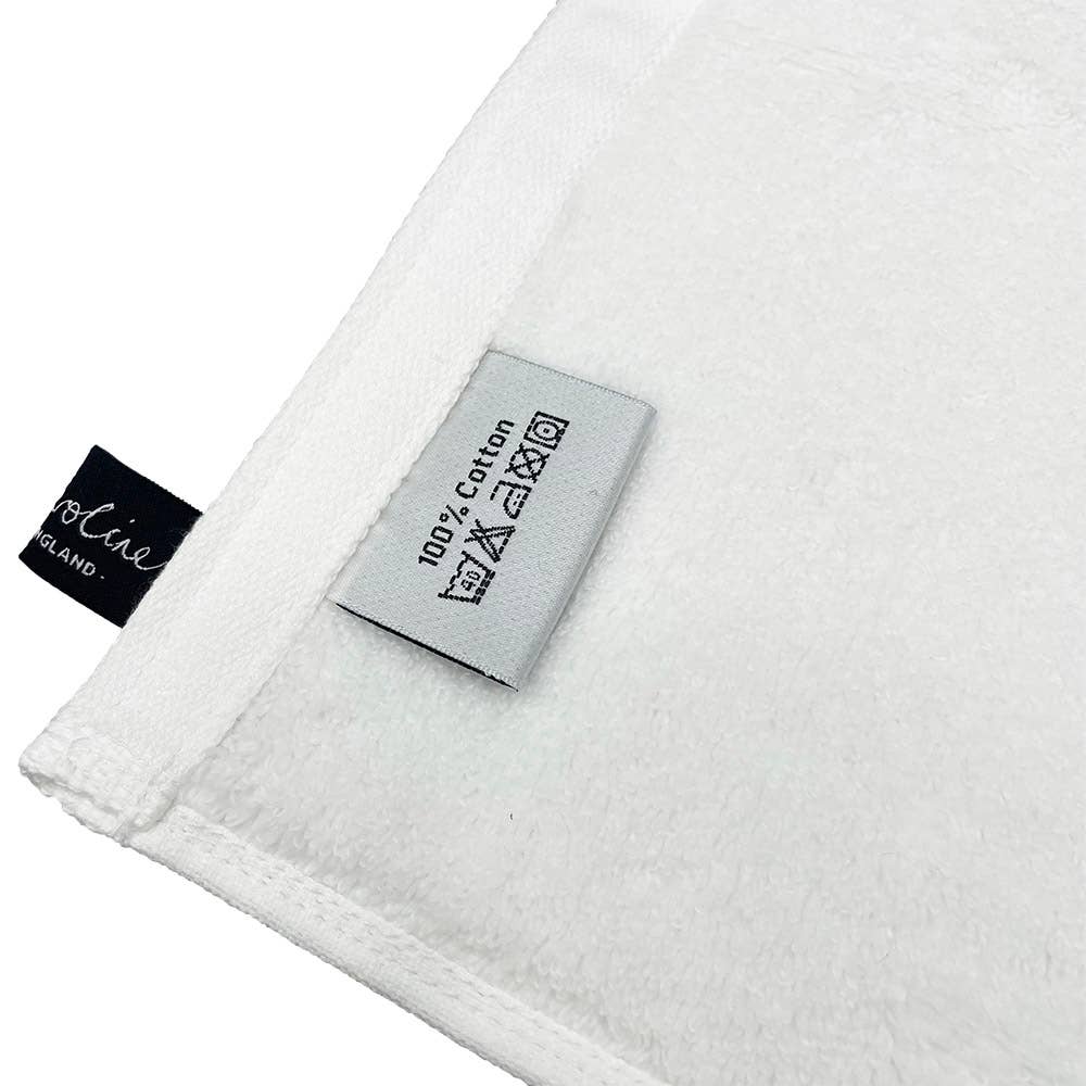 Reusable Face cloth in Liberty Wiltshire Woodland on one side and white cotton on the other side. Shows washing label, 100% cotton can go in the washing machine.