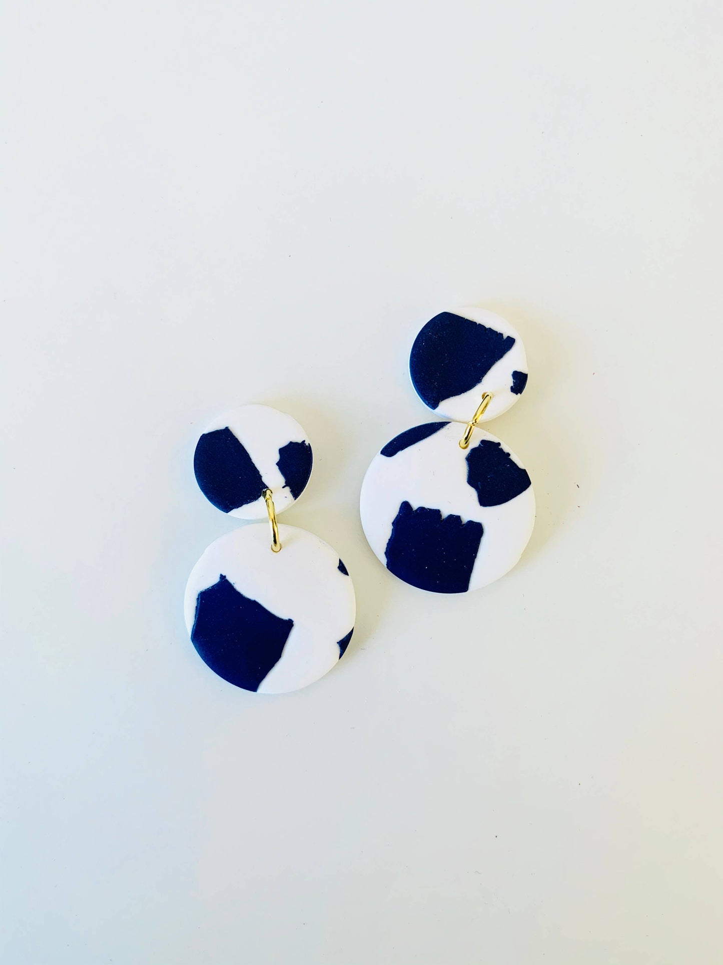 Close-up of Catalina blue and white polymer clay drop earrings, showing intricate pattern and silver-plated nickel-free findings.