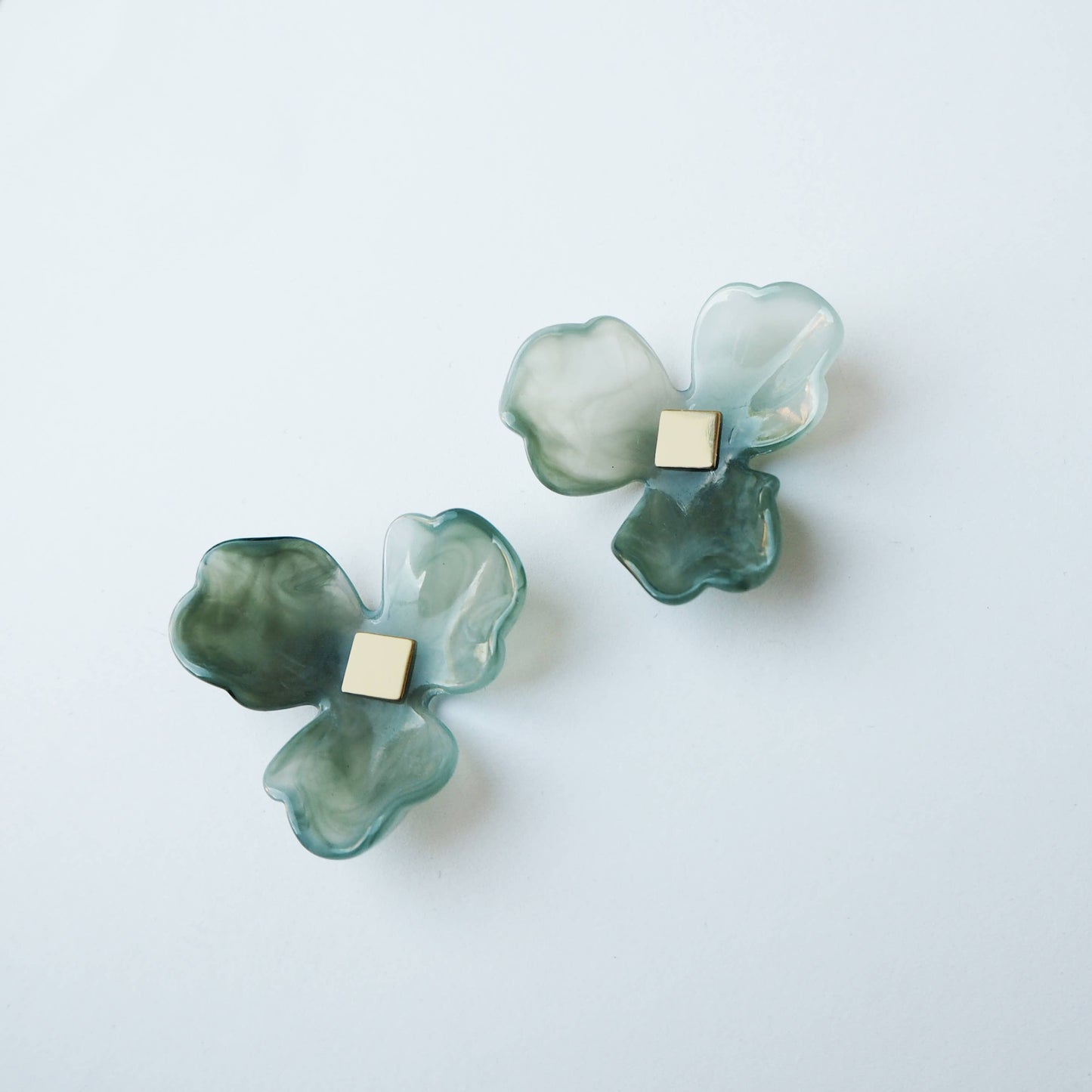 Model wearing Maxi Bloom seafoam green flower statement stud earrings