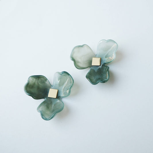 Model wearing Maxi Bloom seafoam green flower statement stud earrings