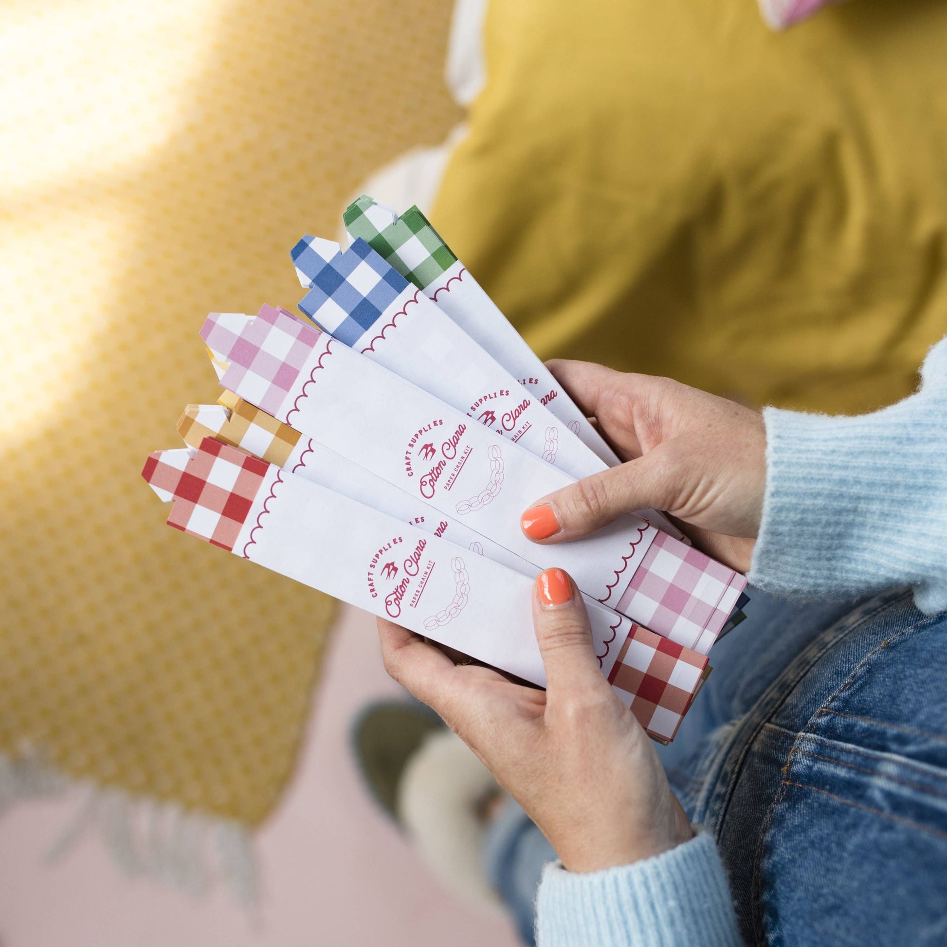 Festive gingham reusable paper chain kit with 48 pre-cut strips in assorted colours, no glue or tape needed, packaged in recyclable UK-made envelope