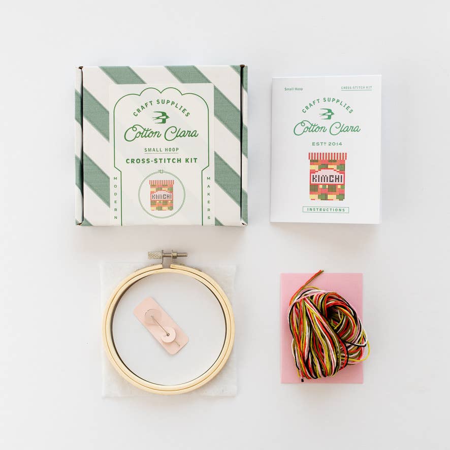 Kimchi Mini Cross Stitch Kit neatly packaged in a plastic-free, recyclable striped box, with kit contents visible beside it.