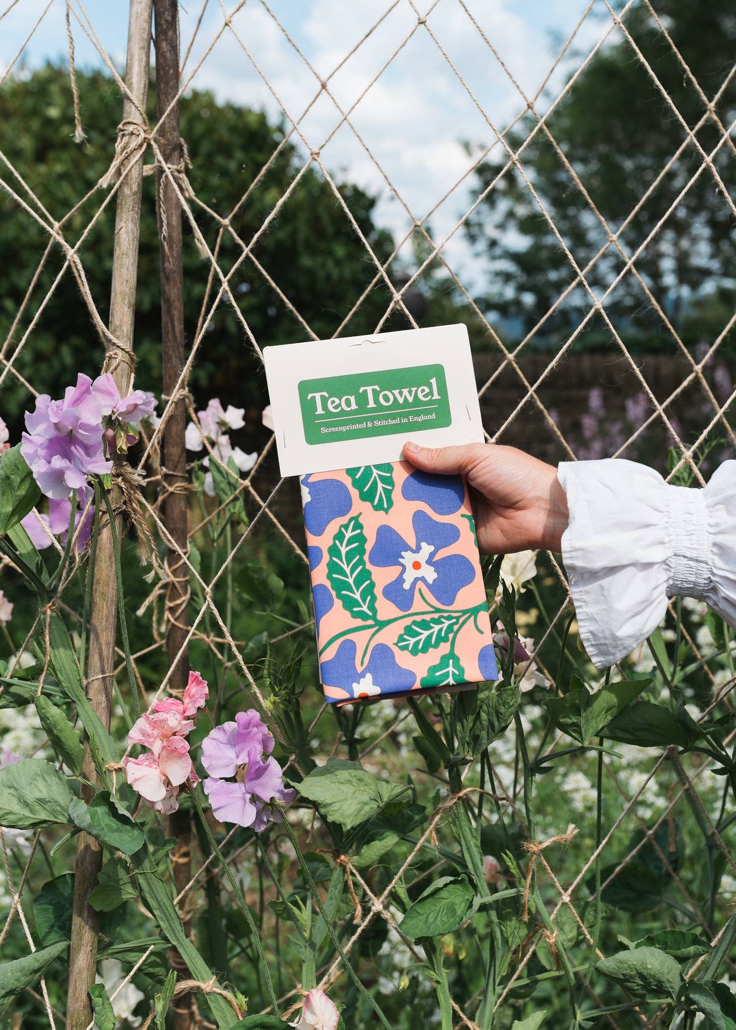 Primrose tea towel with floral screenprint on unbleached natural cotton by Studio Wald.