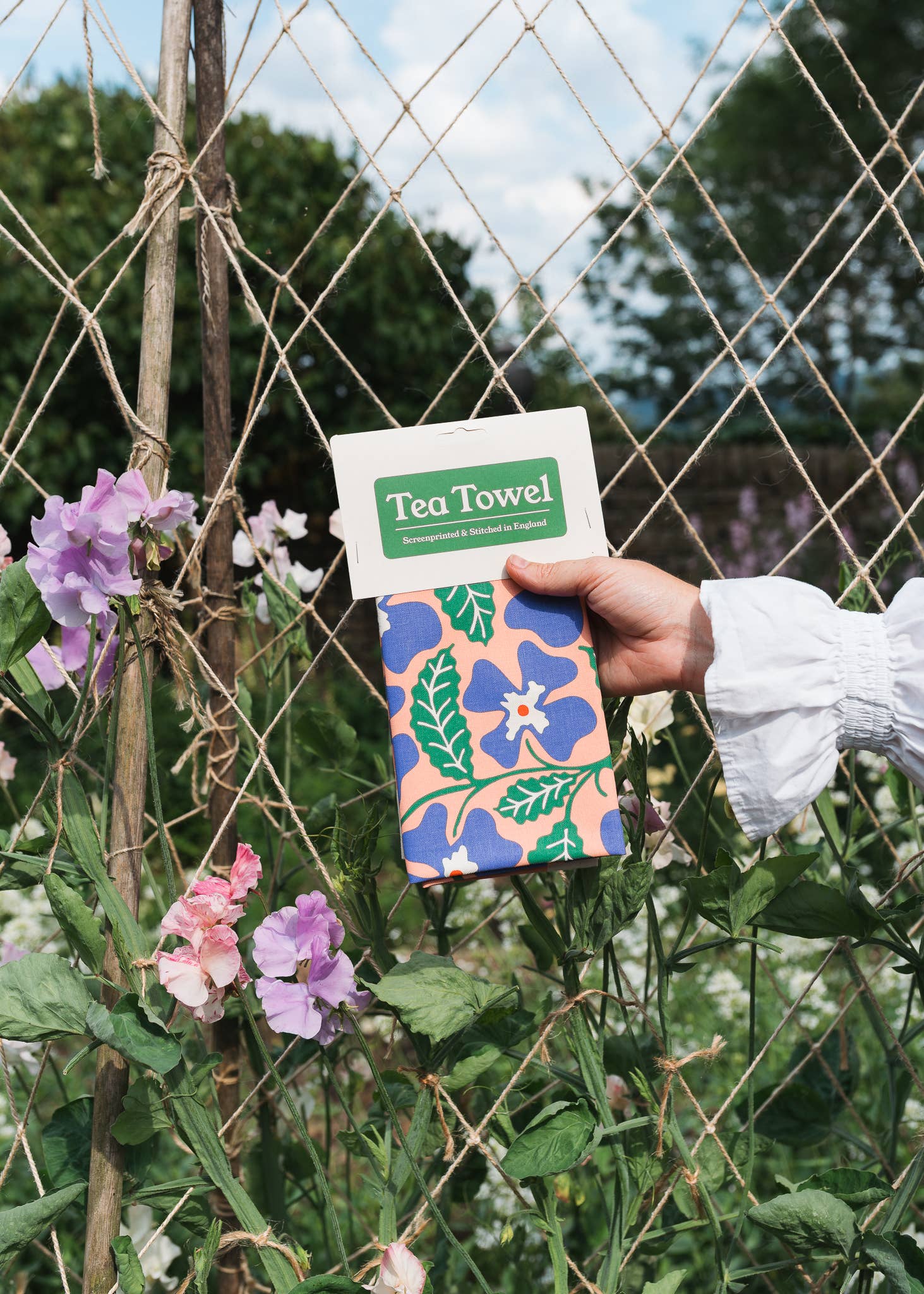 Primrose tea towel with floral screenprint on unbleached natural cotton by Studio Wald.