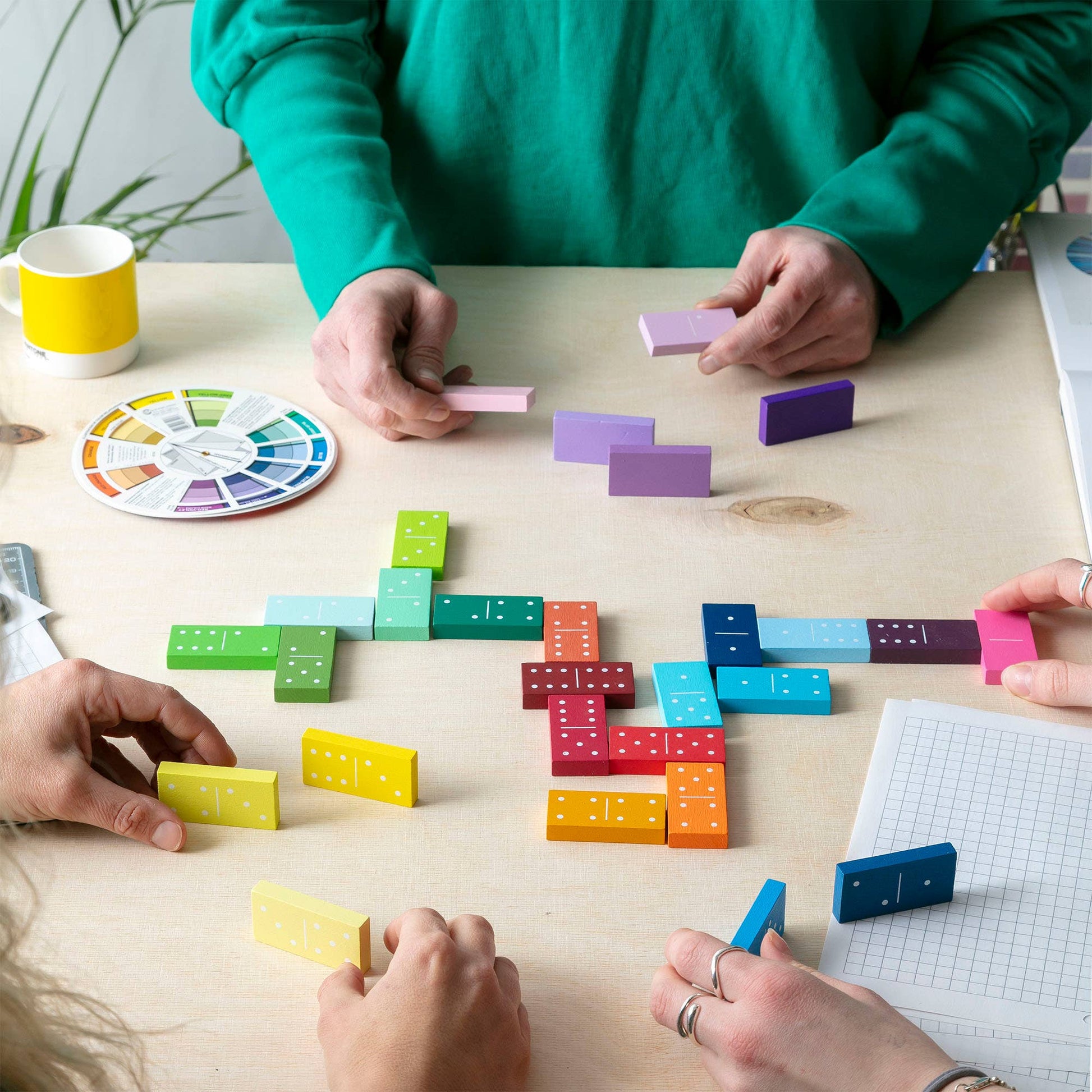 Gradient dominoes creating a colourful domino rally.