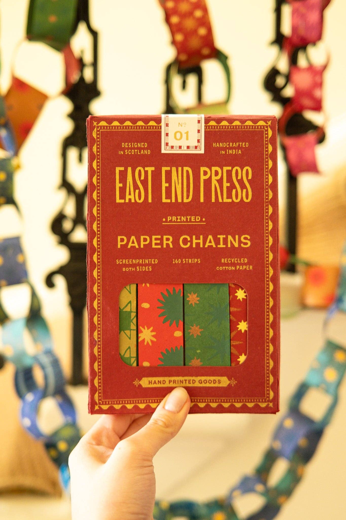 Recycled festive paper chain strips, hand-printed double-sided, eco-friendly decoration kit.