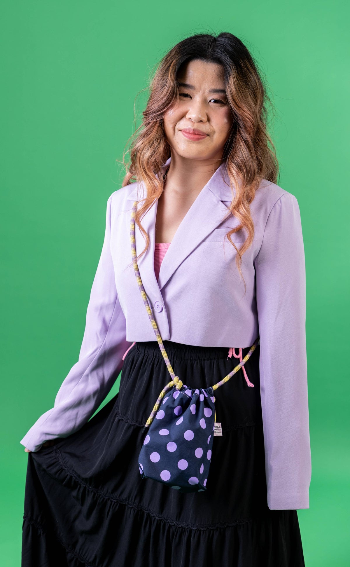 Mini drawstring crossbody bag in polka dots