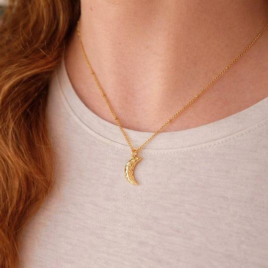 Close up of the textured finish on the Gold Crescent Moon Necklace charm