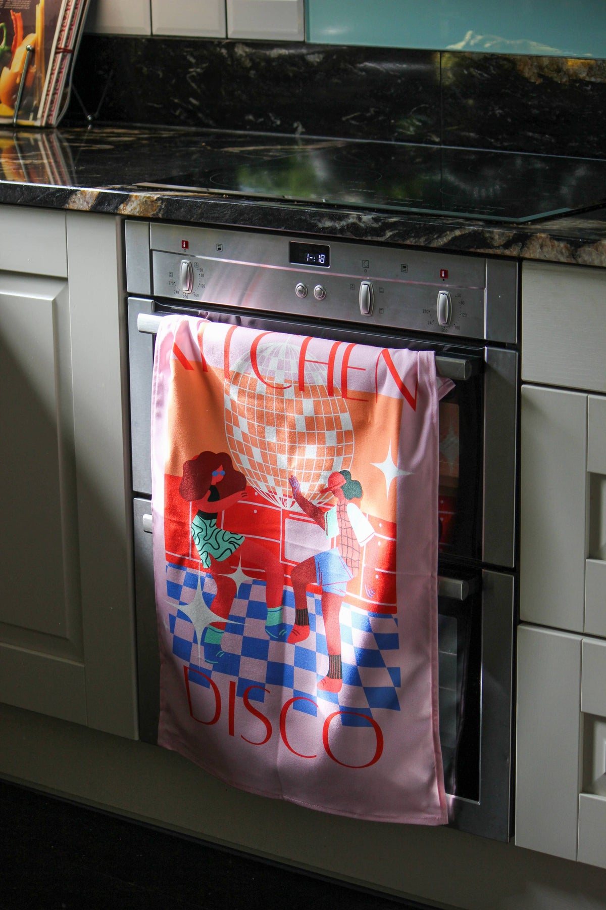 Vibrant pink cotton tea towel featuring diverse dancers