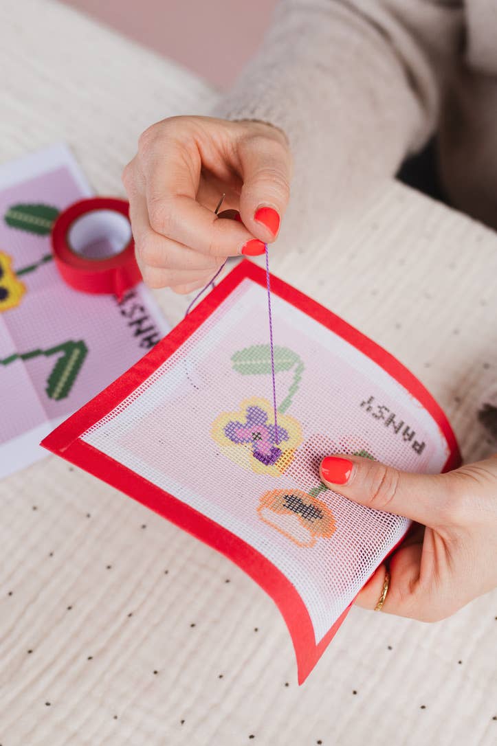 Close-up of the tapestry needle and stitch chart in the craft kit