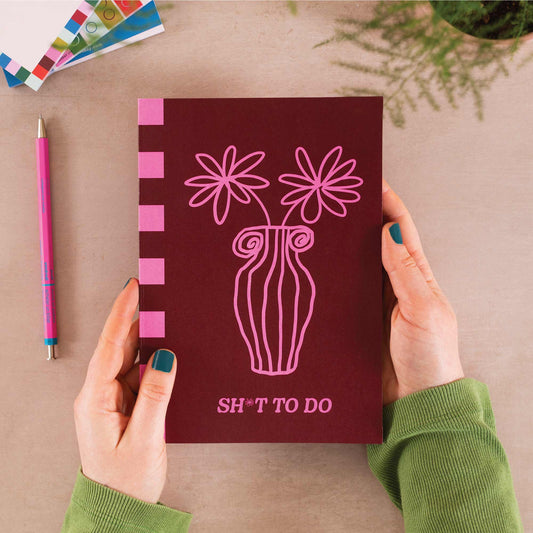 A5 Hot Pink Bloom Notebook with vibrant floral cover in hot pink and burgundy, minimalist bellyband, 60 recycled lined pages, UK made.