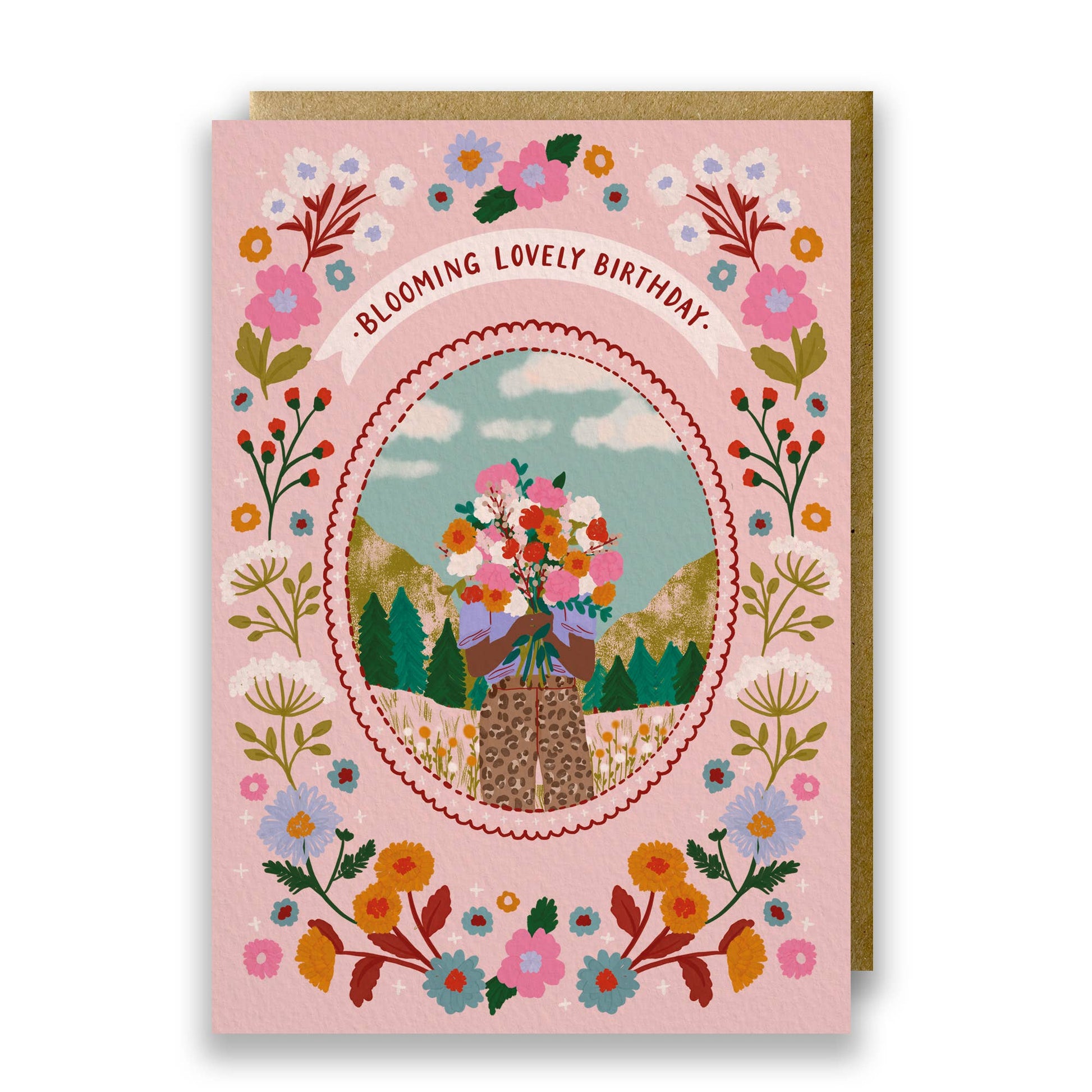 Blooming Lovely Birthday Card featuring a woman with a floral bouquet in a mountain scene