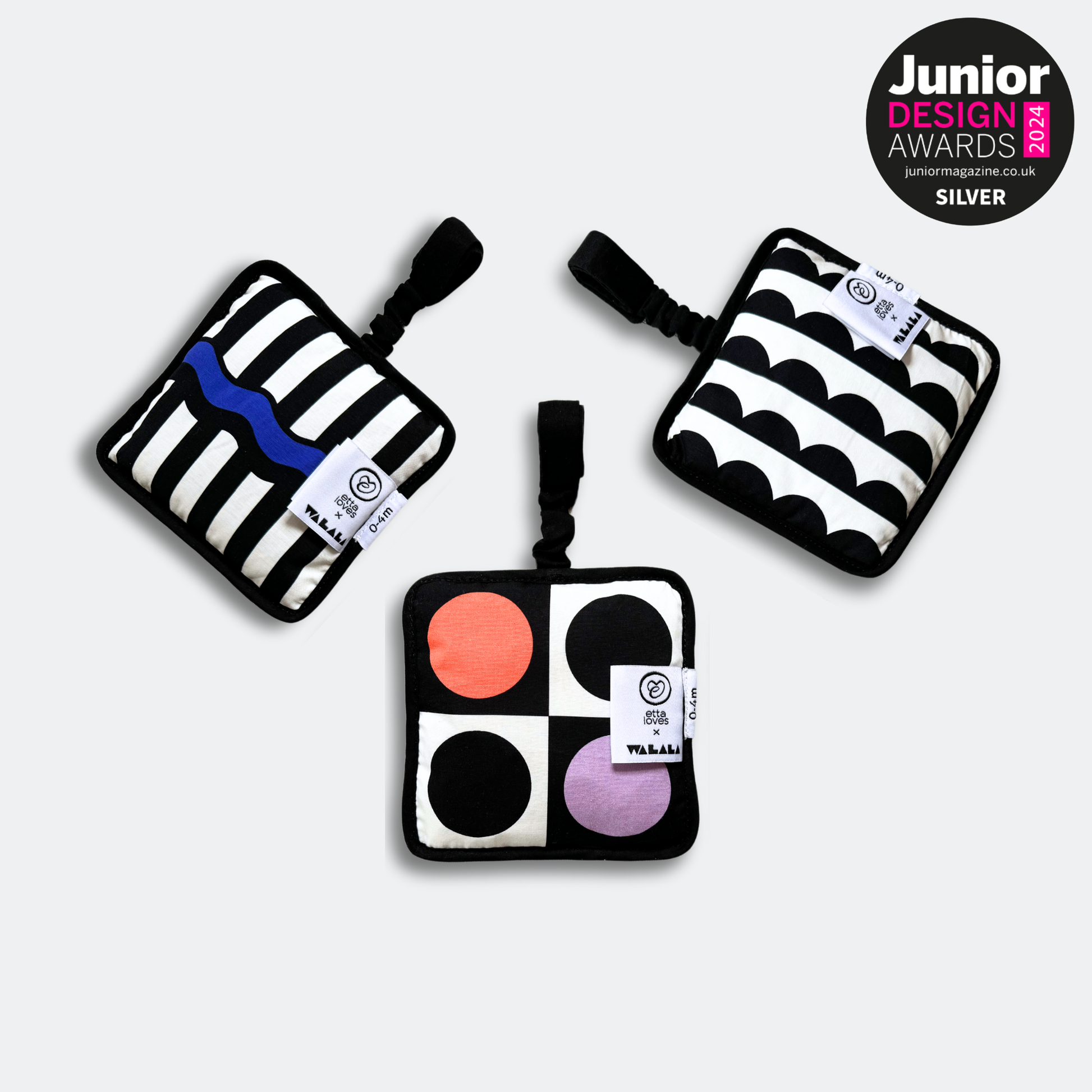 Baby engaging with Etta Loves x Walala Sensory Hanging Square during tummy time