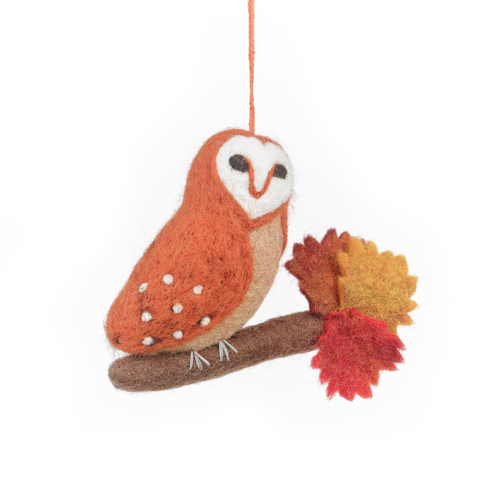 Felt owl ornament with autumn leaves . Handmade felt barn owl hanging decoration with burnt orange body, crafted for autumn, sustainable and fair trade artisan product