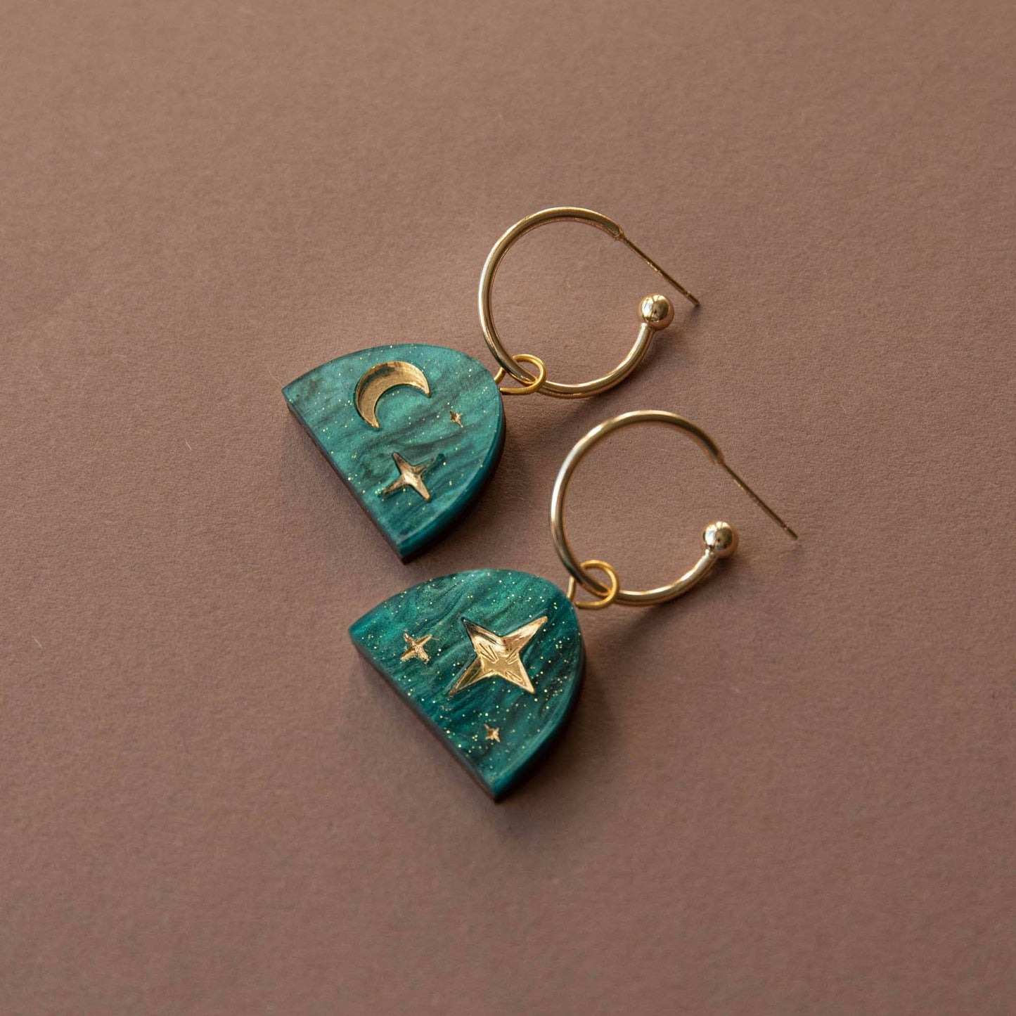 Moon Rising Arc Hoop Earrings in Teal Marble & Gold, displayed in a Kraft gift box, ready for gifting.
